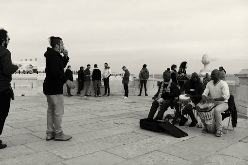 Lisbon, Portugal - Mars 13, 2022: Street musicians play percussion by the Tagus River in Lisbon downtown.