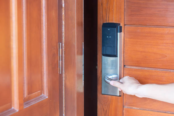 istock man holding handle of smart digital door lock while open or close the door. Technology, electrical and lifestyle concepts 1408014580