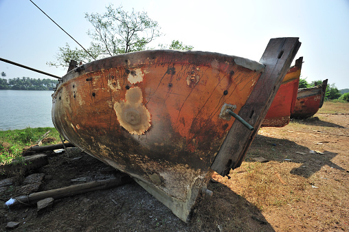 Dilapidated boats parked near creeks shore near village Achara district Sindhudurga state Maharashtra india