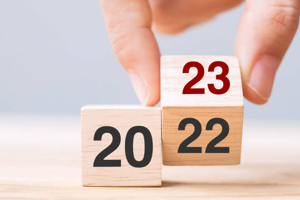 istock hand flip cube block 2022 to 2023 text on table. Resolution, review, strategy, end year, goal, business and New Year holiday concepts 1408017789
