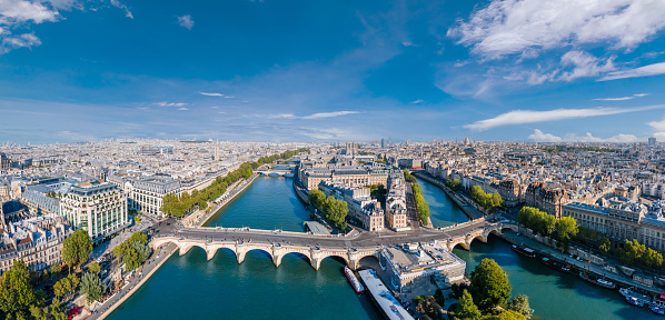 Paris aerial panorama with river Seine, Pont Neuf bridge, ile de la cite and Notre-Dame church, France. Holidays vacation destination. Panoramic view above historical Parisian buildings and landmarks.