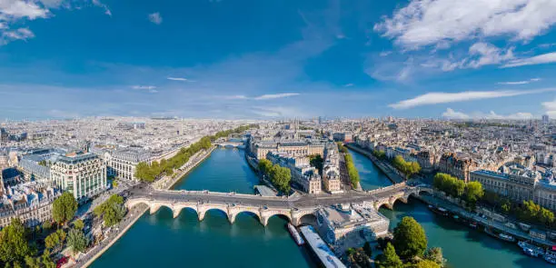 Photo of Paris aerial panorama with river Seine, Pont Neuf bridge, ile de la cite and Notre-Dame church, France. Holidays vacation destination. Panoramic view above historical Parisian buildings and landmarks.