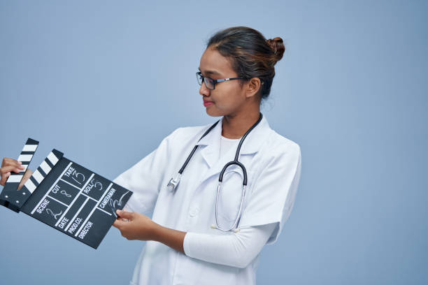 istock young doctor with clapper board work life balance 1408018655