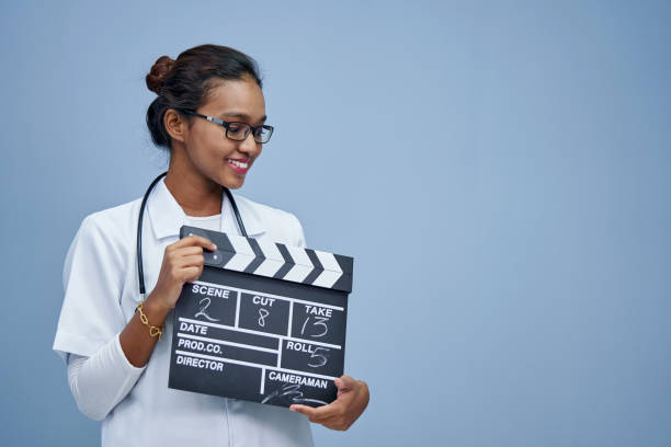 istock young doctor with clapper board work life balance 1408018702