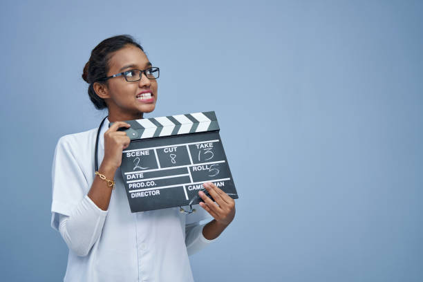 istock young doctor with clapper board work life balance 1408018704