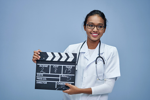 young doctor with clapper board work life balance