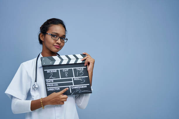 istock young doctor with clapper board work life balance 1408018730