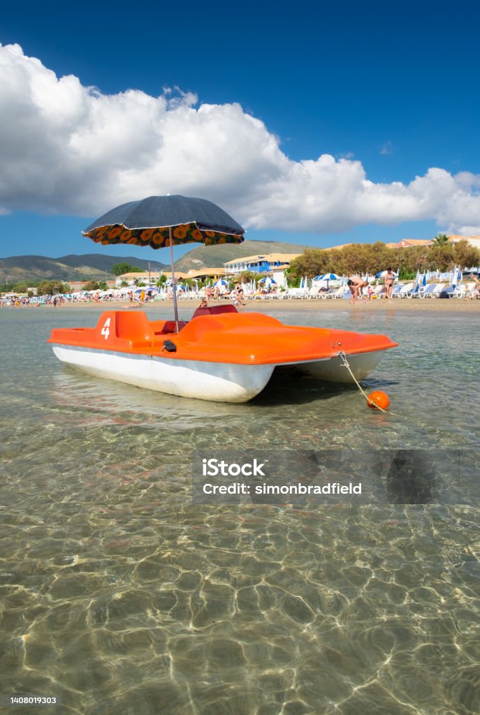 Laganas Beach Holiday Scene A brightly coloured pedalo in the shallow waters of Laganas Beach on the Greek island of Zakynthos. Beach Stock Photo