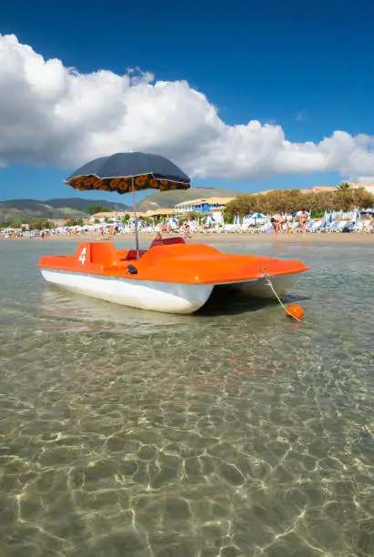 A brightly coloured pedalo in the shallow waters of Laganas Beach on the Greek island of Zakynthos.