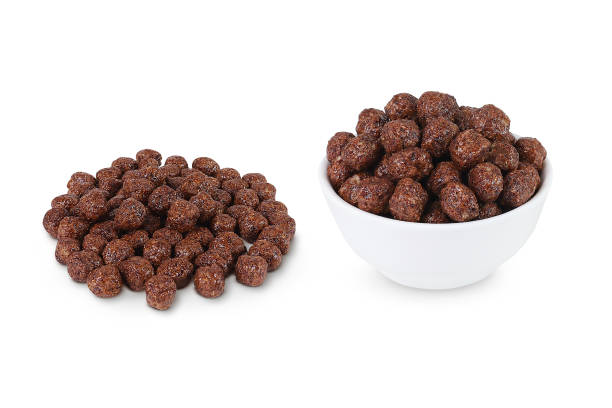 istock Chocolate corn flakes isolated on white background. Heap of corn flakes and corn flakes in white bow 1408019355