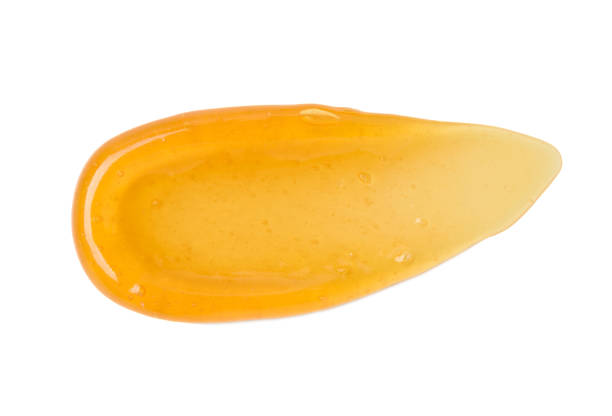 istock Clear transparent orange gel smear smudge with bubbles isolated on white background 1408019563