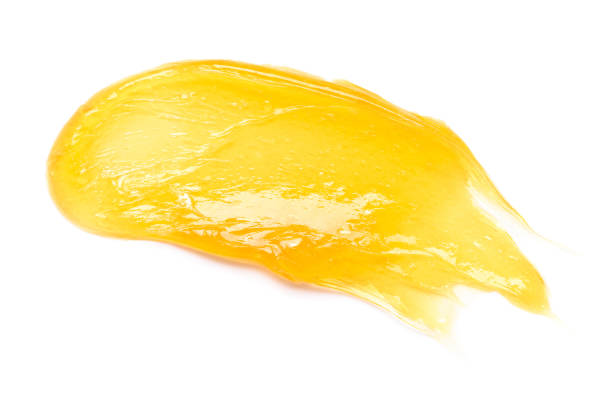 istock Yellow gel sugar honey smear smudge macro isolated on white background 1408019575