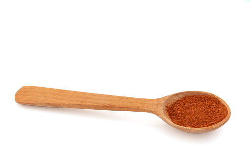 Isolated paprika spoon on a white background