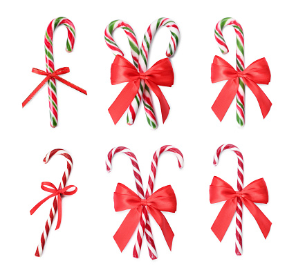 Close up of candy canes arranged in heart shape isolated on white background