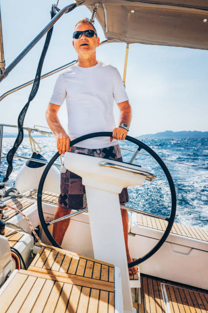 istock Skipper sailing on sailboat 1408022654