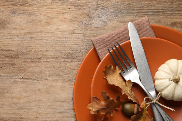 istock Festive table setting with autumn decor on wooden background, top view. Space for text 1408022665