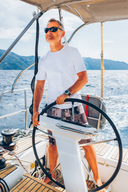 istock Skipper sailing on sailboat 1408022774