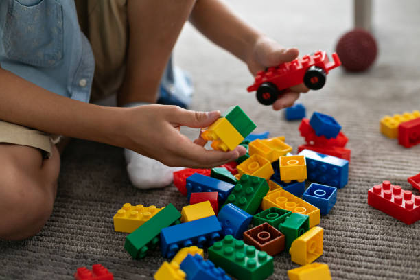istock Little toddler boy playing with colorful plastic blocks at home building creative game, imagination 1408023029