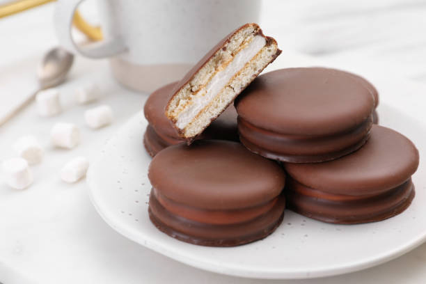 istock Saucer with delicious choco pies on white table, closeup 1408024241