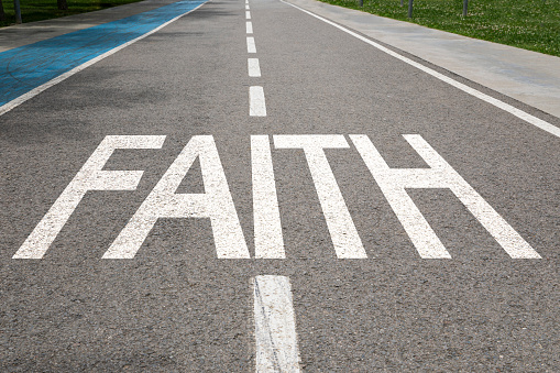 Faith written on city road