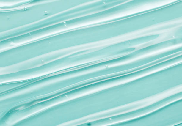 Liquid gel beauty serum texture. Beauty skincare liquid gel on mint green background with bubbles. Skincare hygiene product closeup. stock photo