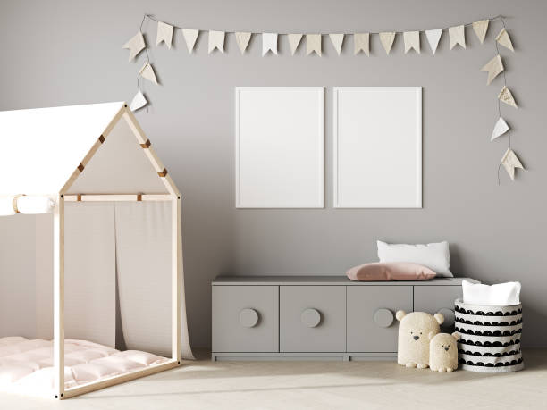 istock Blank poster frames mock up on gray wall in nursery room interior background with baby bedding, soft toys, garland flags, 3d rendering 1408026363