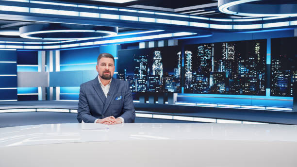 istock Beginning Evening News TV Program: Anchor Presenter Reporting on Business, Economy, Science, Politics. Television Cable Channel Anchorman Talks. Broadcast Network Newsroom Studio. 1408026538