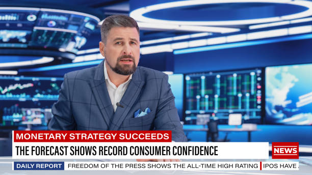 istock TV Live News Program: Charismatic White Male Presenter Reporting. Television Cable Channel Anchorman or Host Talking about Important Events. Network Broadcast Mock-up. Modern Newsroom Studio 1408027516