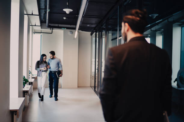 istock Colleagues moving in office lobby 1408028971