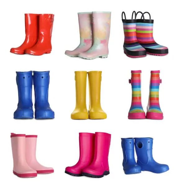 Set with different colorful rubber boots on white background