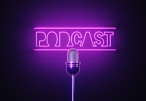Purple neon light writes podcast above a silver colored microphone over black background. Horizontal composition with copy space.