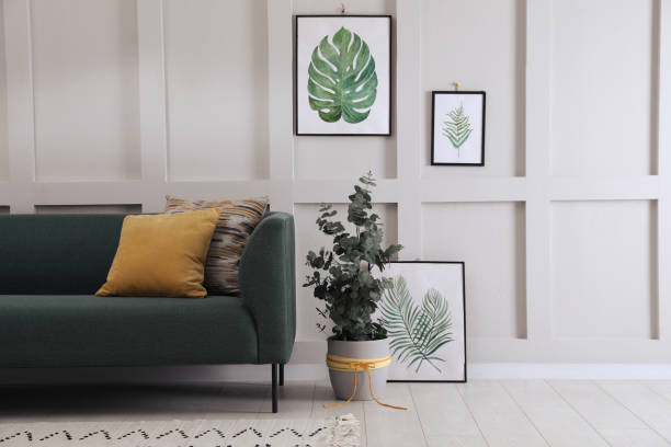 istock Living room with stylish sofa, beautiful eucalyptus and decorative elements. Interior design 1408029422