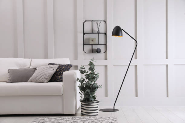 istock Living room with stylish sofa, beautiful eucalyptus and decorative elements. Interior design 1408029451