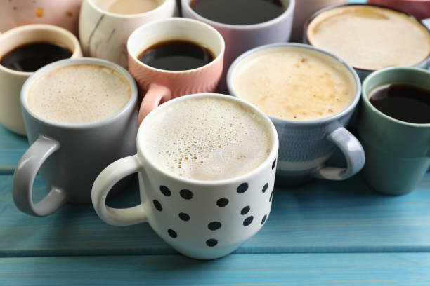istock Many cups of different coffee drinks on light blue wooden table 1408029538