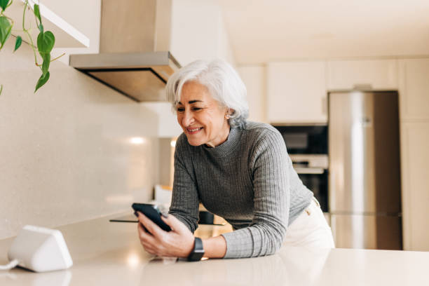istock Senior woman talking to a virtual assistant on her smart speaker 1408029589