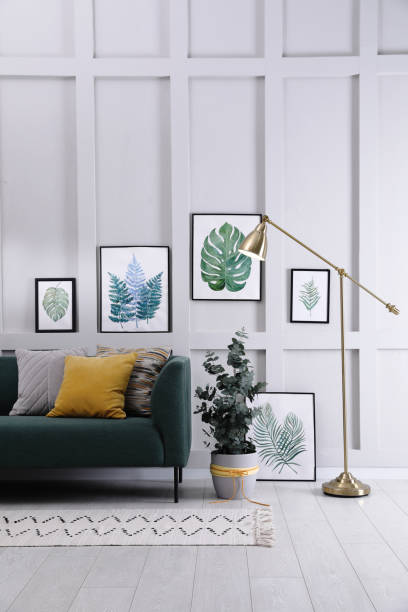 istock Living room with stylish sofa, beautiful eucalyptus and decorative elements. Interior design 1408029637