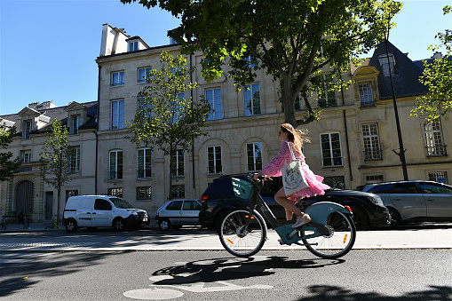 Paris, France-07 08 2022: Cyclist riding on a cycle path on a Parisian street, France.