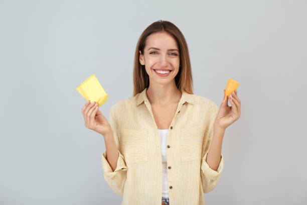 istock Happy young woman with menstrual cup and disposable pad on grey background 1408030737