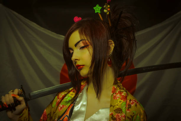 Beautiful asian young woman with katana over japanese flag