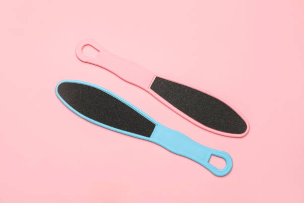 istock Colorful foot files on pink background, flat lay. Pedicure tools 1408032662