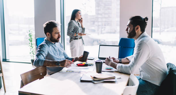 istock Colleagues discussing business issue in office 1408033704