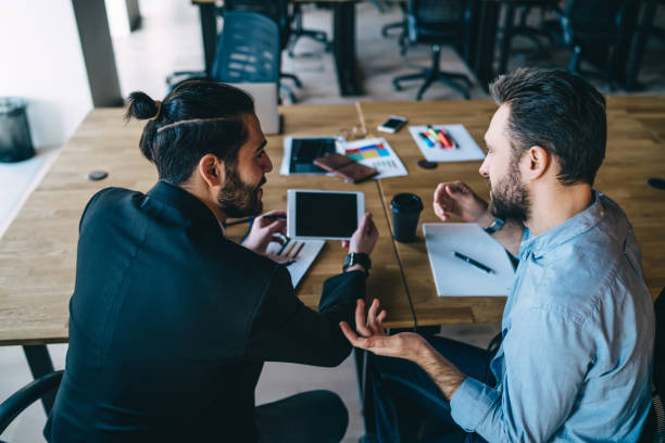 istock Businessmen discussing new project and using tablet in workplace 1408033737
