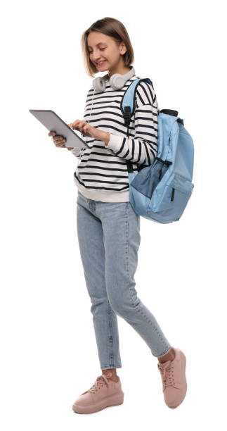 istock Young student with tablet, backpack and headphones on white background 1408034699