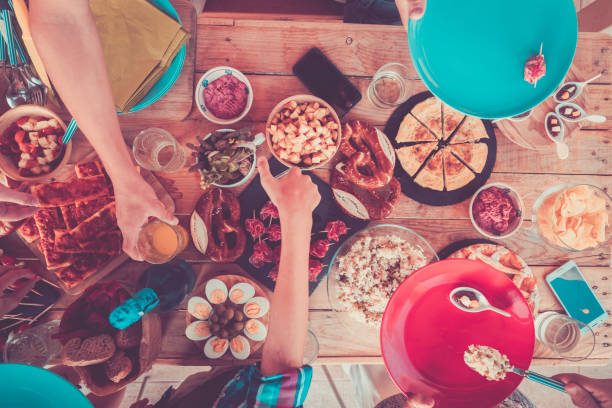 istock People Having Food At Table During Birthday Party 1408034892