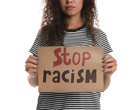 African American woman holding sign with phrase Stop Racism on white background, closeup