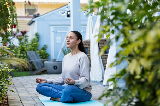 istock Multiracial woman meditating on patio 1408038634