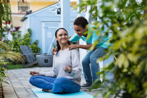 istock Mother smiling, meditation interrupted by hug from son 1408038672