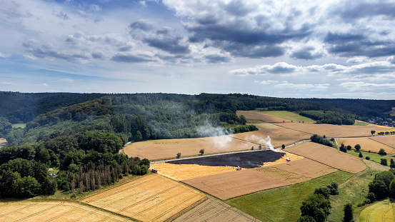 Large grass fire on a wheat field due to a prolonged drought - aerial view