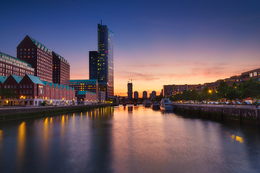 Rotterdam, Netherlands. View of the city center. Cove and pier for boats and ships. Panoramic view. Cityscape in the evening. Skyscrapers and buildings.