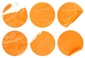 six round orange stickers